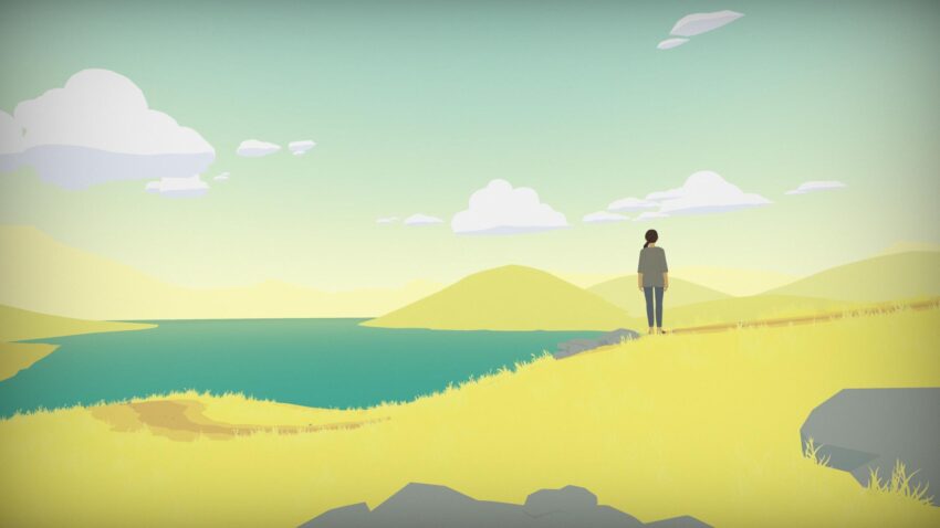 Hindsight - a person stands in a field, looking out at the nearby ocean