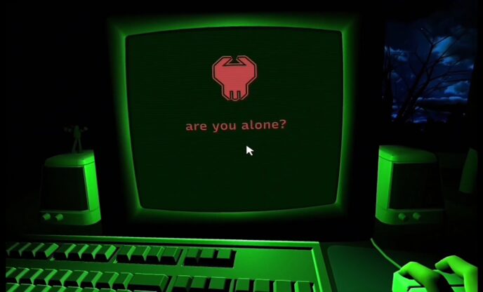 Dreader - A person sitting at a computer that is giving off green light. A red message on the screen is asking if they are alone.
